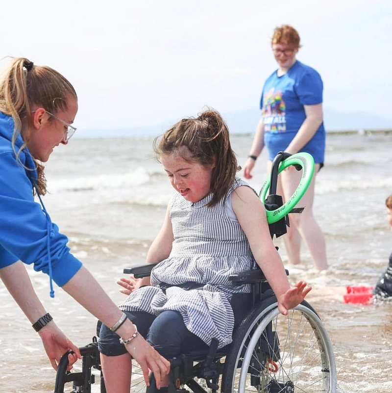 Girl in wheelchair at beach