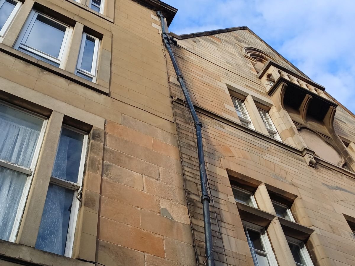 Broken downpipe on Edinburgh tenement block